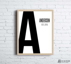 a black and white poster on a brick wall with the letter a in it's center