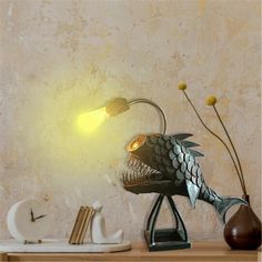 a fish lamp sitting on top of a wooden table