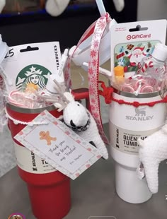 two starbucks cups filled with candy and stuffed animals