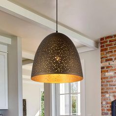 a kitchen with a table and chairs under a large light fixture over the stove top