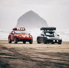 two cars are parked on the beach next to each other