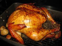 a roasted turkey sitting on top of a grill