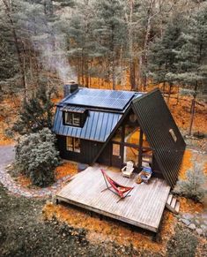 an aerial view of a cabin in the woods