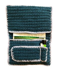 a crocheted pouch with two toothbrushes and some other items in it