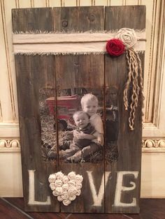 a wooden frame with an image of a baby in it and the words live written on it