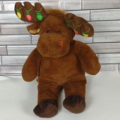 a brown moose stuffed animal sitting on top of a table