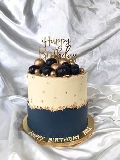 a birthday cake with gold and blue decorations