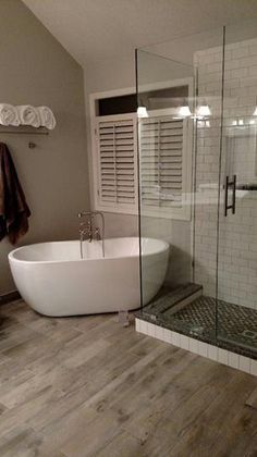 a bathroom with a bathtub, sink and towel rack