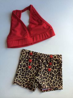 a red top and leopard print shorts on a white surface