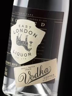 a close up of a bottle of wine on a black background with a label that reads east london liquor co ltd