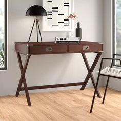 a wooden desk with two drawers and a lamp on the table in front of it