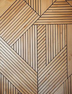 a wooden paneled wall with geometric designs on it