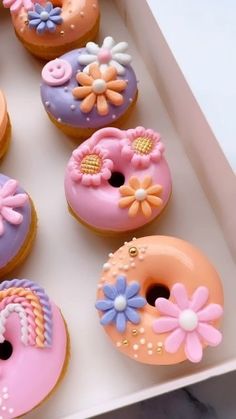 there are many decorated doughnuts in the box