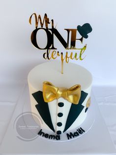 a cake with a tuxedo and bow tie on it that says onederful