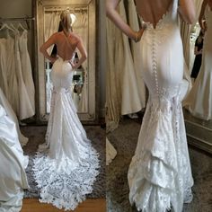 the back of a woman's white wedding dress in front of a mirror with her reflection