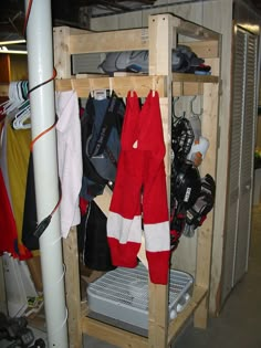 a wooden shelf filled with ski gear and snowboard equipment on it's sides