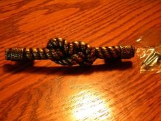 a close up of a rope on a table near a bag of candy and a plastic wrapper