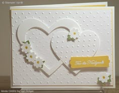 a card with two hearts and flowers on it