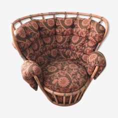 a brown and pink floral chair with matching cushions