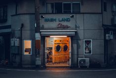 the front entrance to a washer and dryer shop at night