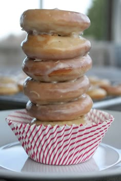 a stack of doughnuts sitting on top of a white plate