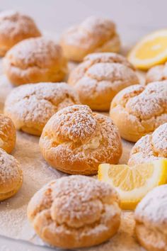 lemon and powdered sugar donuts on a baking sheet, ready to be eaten