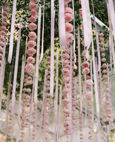 pink flowers and ribbons hanging from the ceiling