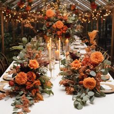 the table is set with orange flowers and candles for an autumn wedding reception or special event