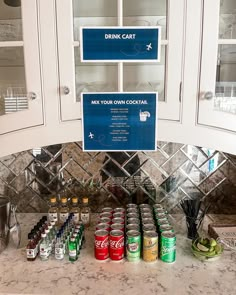 there is a sign on the cabinet above some cans of sodas and other drinks