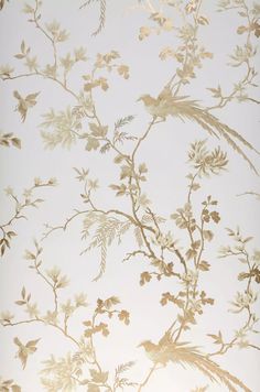 the wallpaper is white and has gold leaves on it