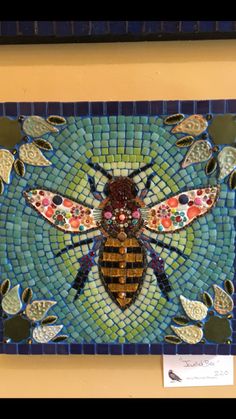 a mosaic art piece with a bee on it