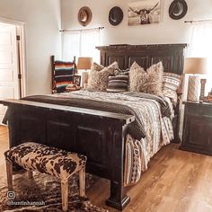 a bedroom with a large bed and wooden floors