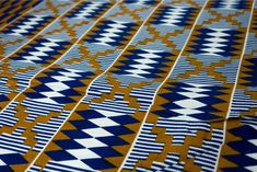 a blue and yellow patterned fabric with an interesting design on the front, side, or back