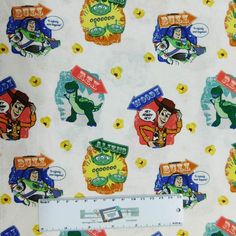 the fabric is very colorful and has cartoon characters on it, as well as a ruler