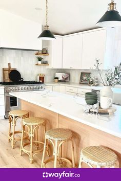 an image of a kitchen setting with stools in the middle and counter tops on both sides