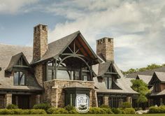 a large house with stone and wood accents