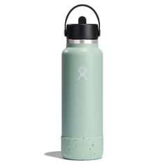 the hydro flask water bottle is shown in light green with black lid and handle