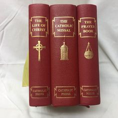 three red books with gold lettering on them