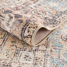 an area rug with multicolored carpeting and a beige, blue, red, yellow and white color scheme