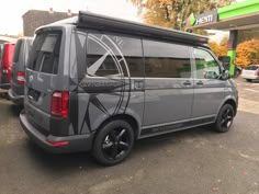 a grey van parked in front of a gas station