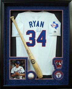 an autographed baseball jersey and bat is in a framed frame with the number 34 on it