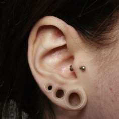 a woman with three piercings on her ear