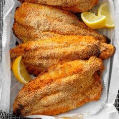 fried fish with lemon wedges in a basket