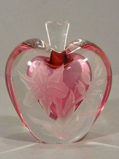 a pink glass apple shaped like a heart