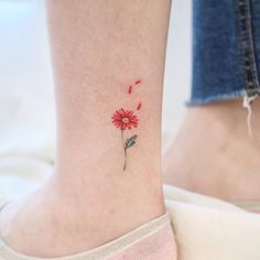 a small red flower on the ankle