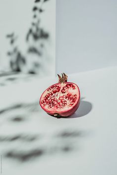 a pomegranate sitting on top of a white table