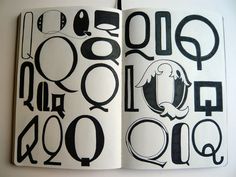 an open book with black and white designs on the pages, including letters and numbers