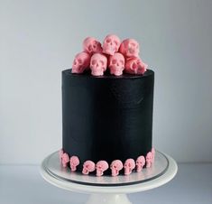 a black and pink cake with skulls on it