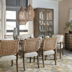 the dining room table is set with beige chairs