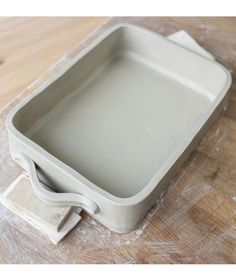 a white square container sitting on top of a wooden table